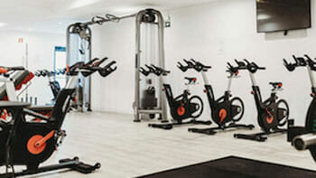 a group of exercise bikes in a gym