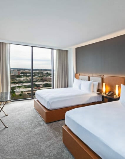 Double queen sized room with view of Houston through floor to ceiling windows