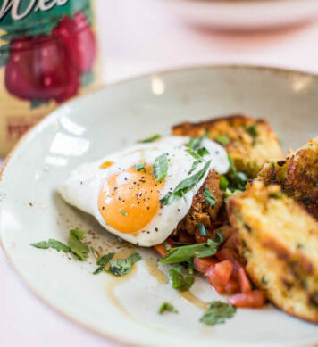 Close up of lightly fried egg served on top of biscuits