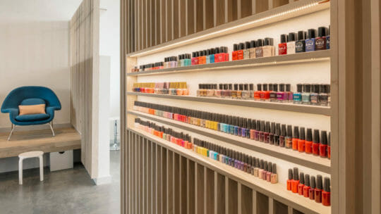 Shelves full of different colored nail polishes at Paloma Nail Salon