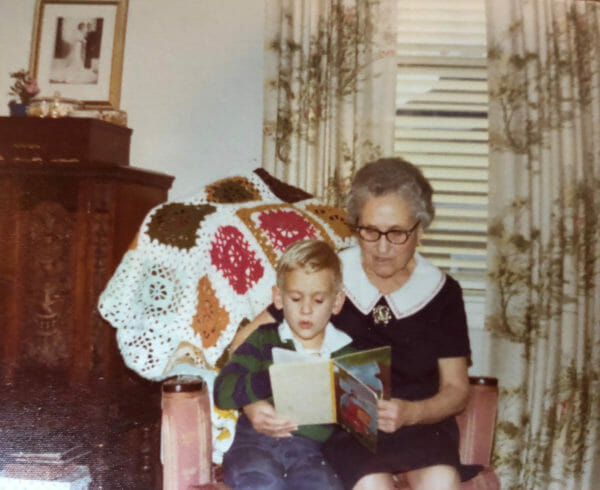 Young Chef Chris Cosentino sitting on his grandmother Rosalie's lap while she reads to him