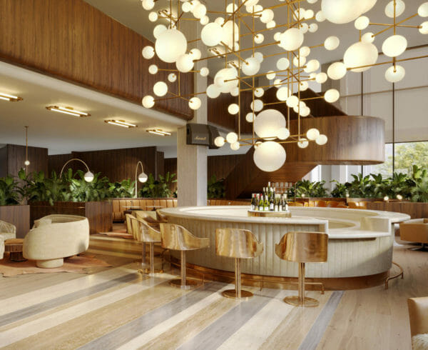 Circular bar encircled with gold bar stools and has spherical ceiling lamps