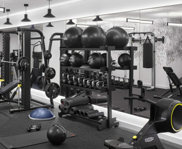 Several spinning bikes and various other fitness equipment in the fitness center