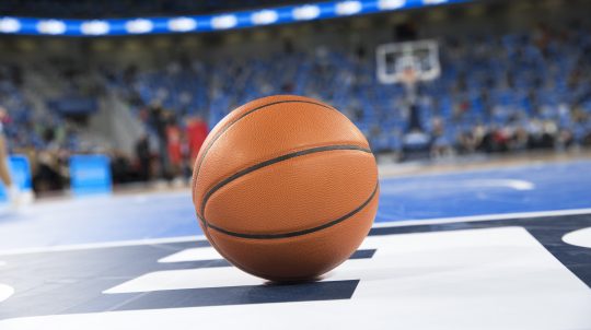 Close-up of basketball on court in stadium.
